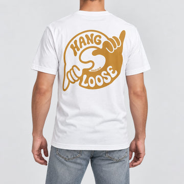 Back view of a model wearing the FIVE2 Hang Loose Tee in White, with a large ochre shaka hand design and Psalm 46:10.