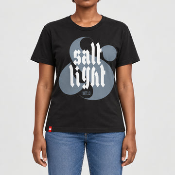 FIVE2 Salt and Light Tee in black, front model view with white gothic salt and light lettering over a gray ampersand and Matthew 5:13.